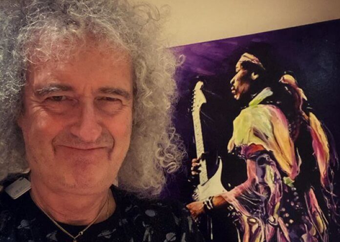 Brian May com pôster de Jimi Hendrix